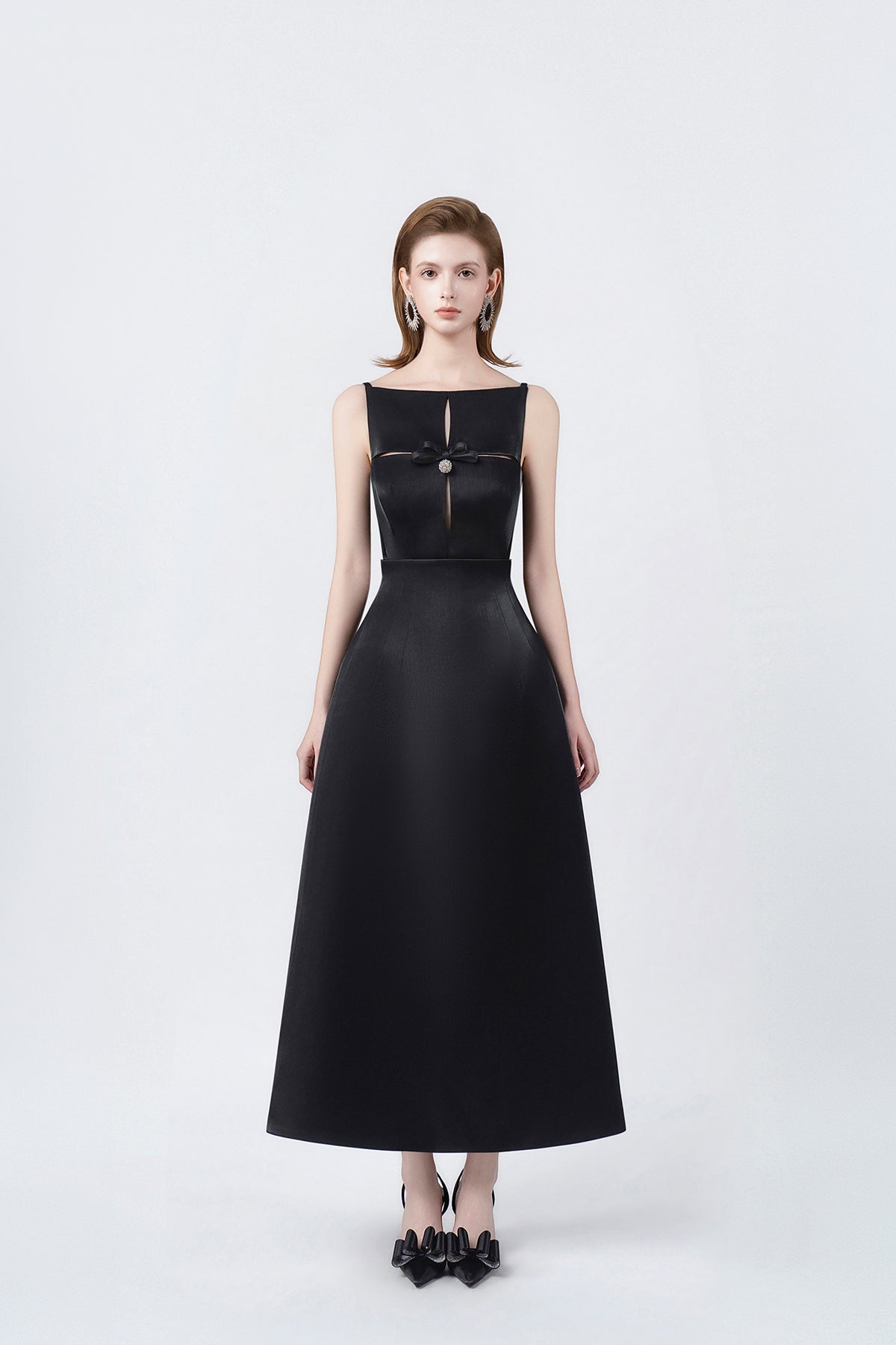 model in a black boat-neck A-line midi dress, DeTHEIA