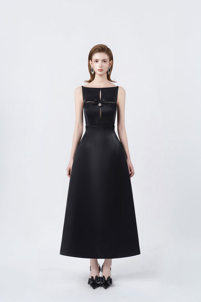 model in a black boat-neck A-line midi dress, DeTHEIA