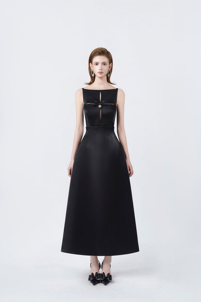 model in a black boat-neck A-line midi dress, DeTHEIA