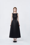 model in a black boat-neck A-line midi dress, DeTHEIA