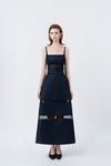 model in a denim-blue A-line midi dress with slim straps and belt, DeTHEIA