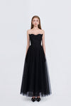 Black strapless gown with tulle skirt on a white background