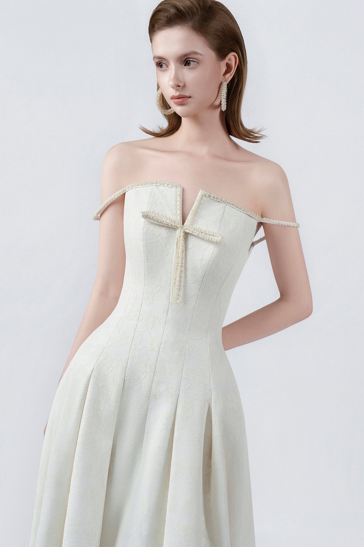 flared hem of the cream maxi dress, DeTHEIA