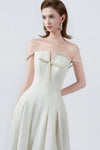 flared hem of the cream maxi dress, DeTHEIA