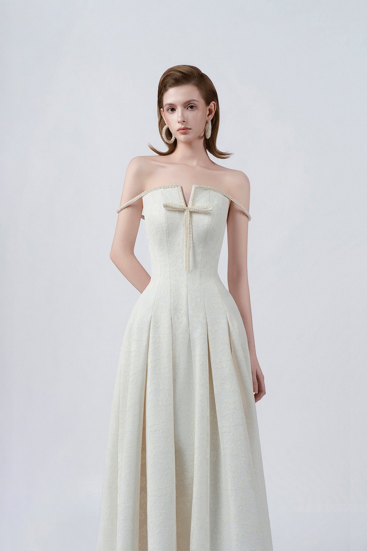 off-the-shoulder neckline and bow on cream, DeTHEIA