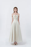 model in a cream off-the-shoulder flared maxi dress, DeTHEIA