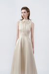 flared hem of the beige midi dress, DeTHEIA