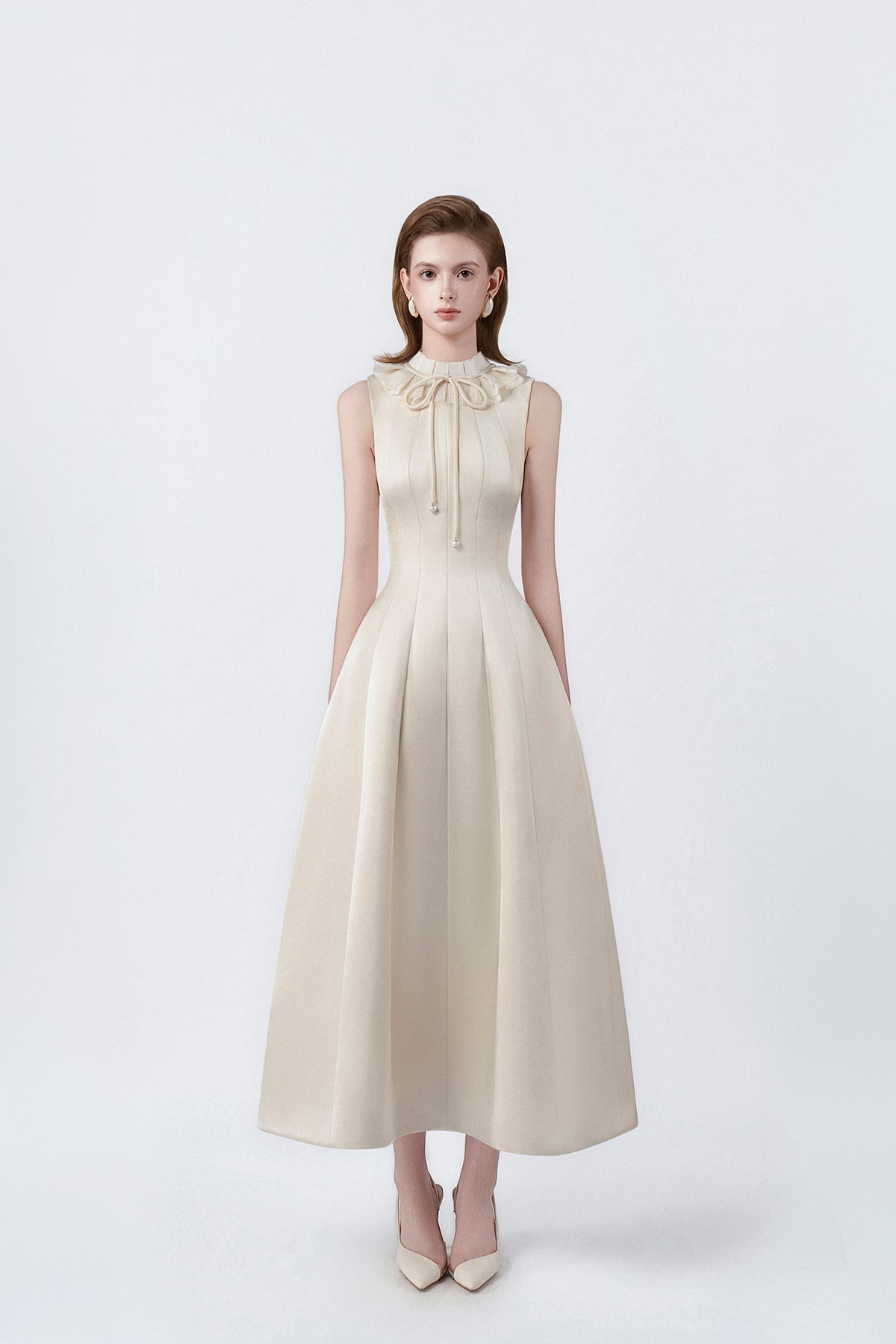model in a beige ruffle-collar flared midi dress, DeTHEIA