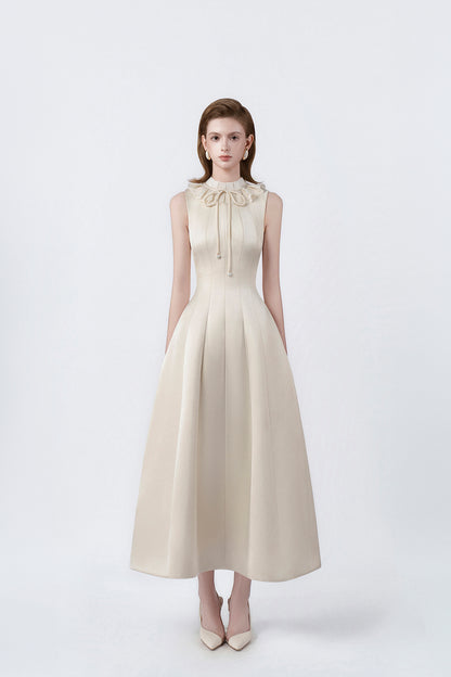 model in a beige ruffle-collar flared midi dress, DeTHEIA