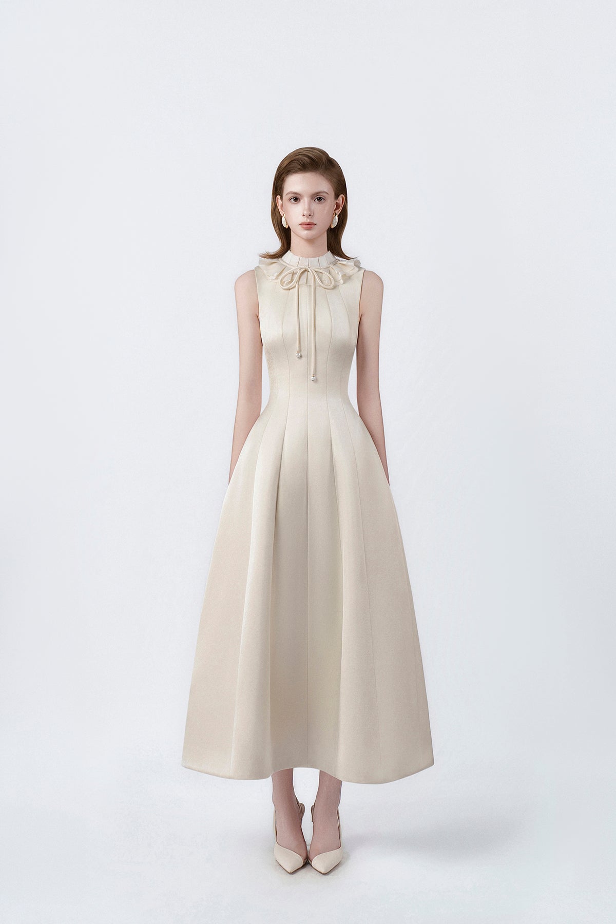 model in a beige ruffle-collar flared midi dress, DeTHEIA