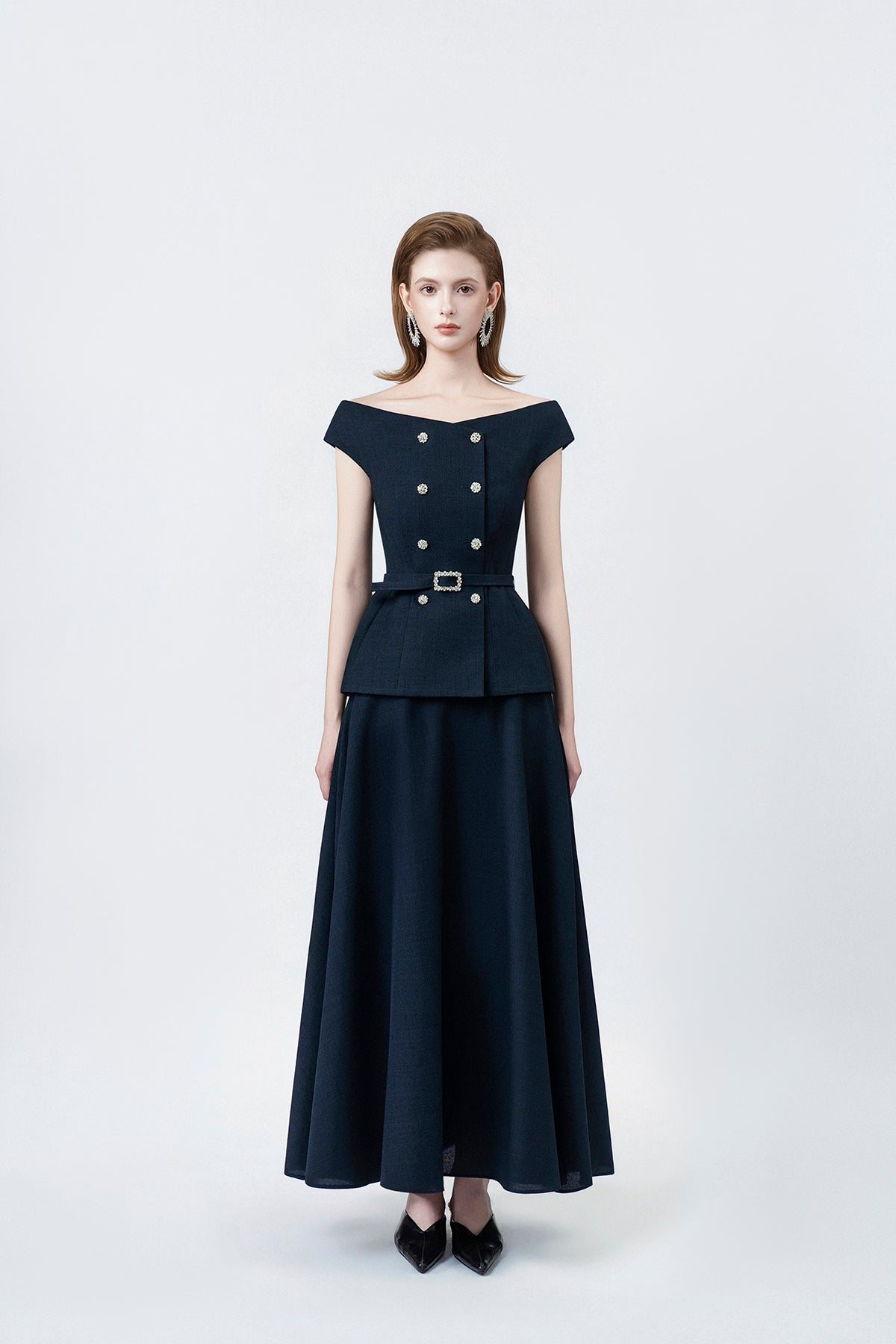 model in a navy high-waisted flared midi skirt, DeTHEIA