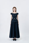 model in a navy high-waisted flared midi skirt, DeTHEIA