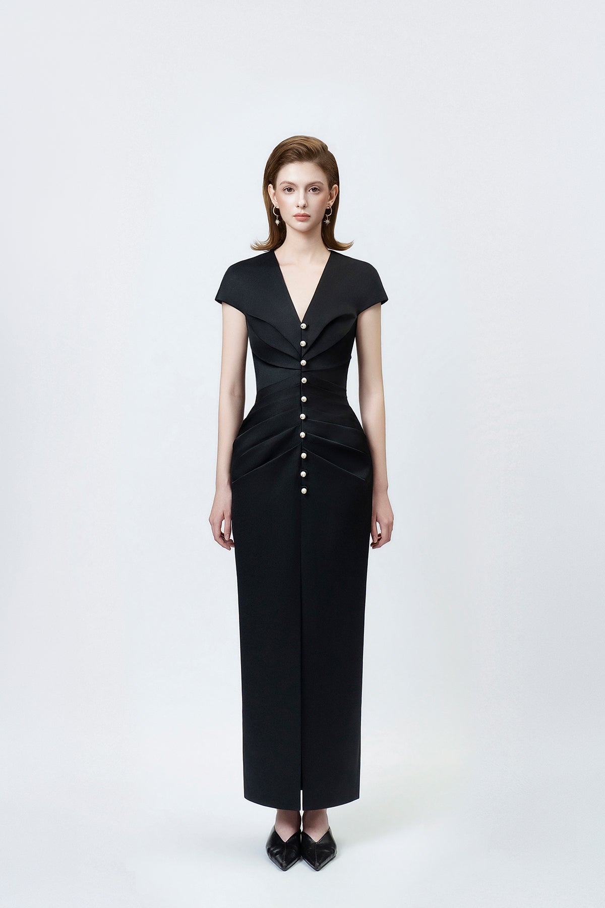 model in a black V-neck pencil midi dress, DeTHEIA