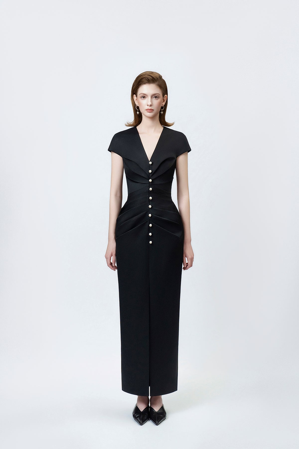 model in a black V-neck pencil midi dress, DeTHEIA