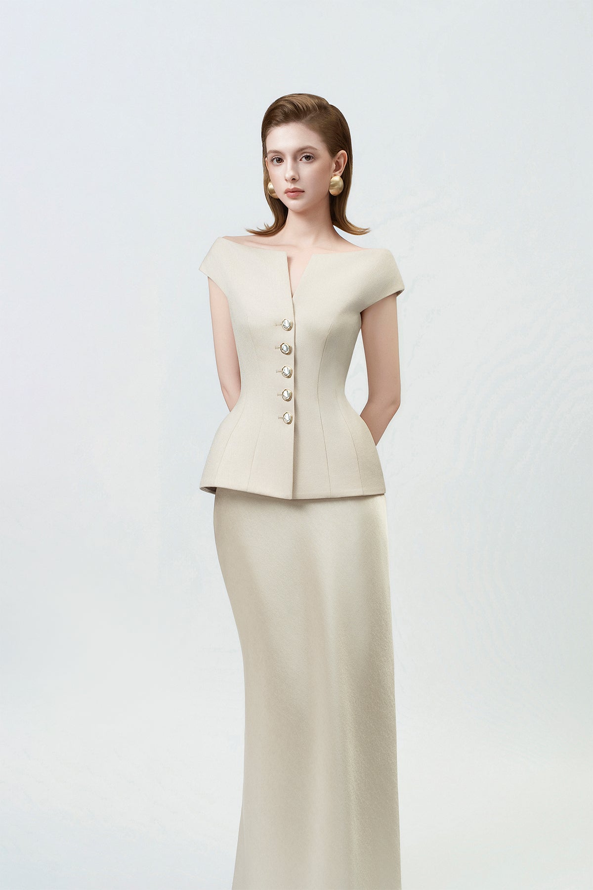 fishtail hem of the gold trumpet skirt, DeTHEIA