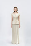model in a gold high-waisted trumpet skirt, DeTHEIA