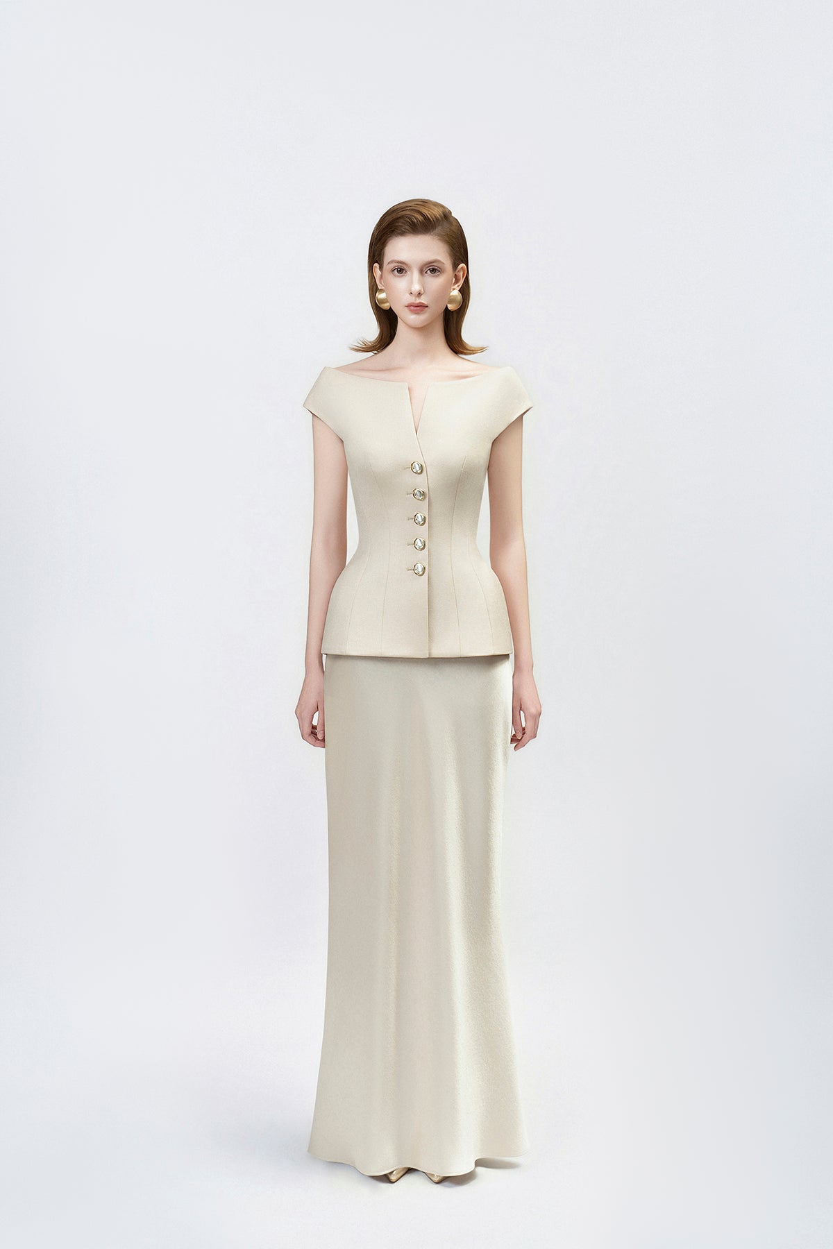model in a gold high-waisted trumpet skirt, DeTHEIA