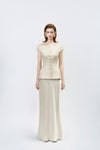 model in a gold high-waisted trumpet skirt, DeTHEIA