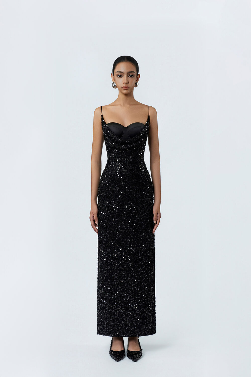 Black evening gown with sequin detailing on a white background