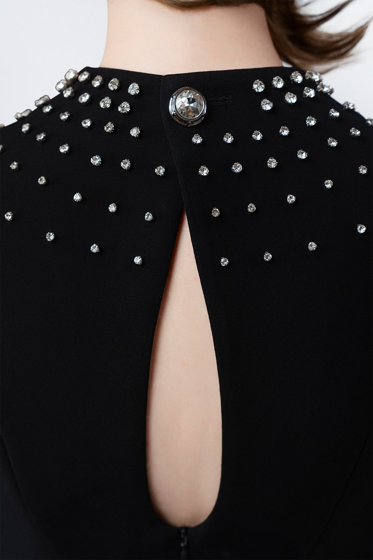 hand-beaded rhinestones on a black midi dress, DeTHEIA