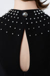 hand-beaded rhinestones on a black midi dress, DeTHEIA