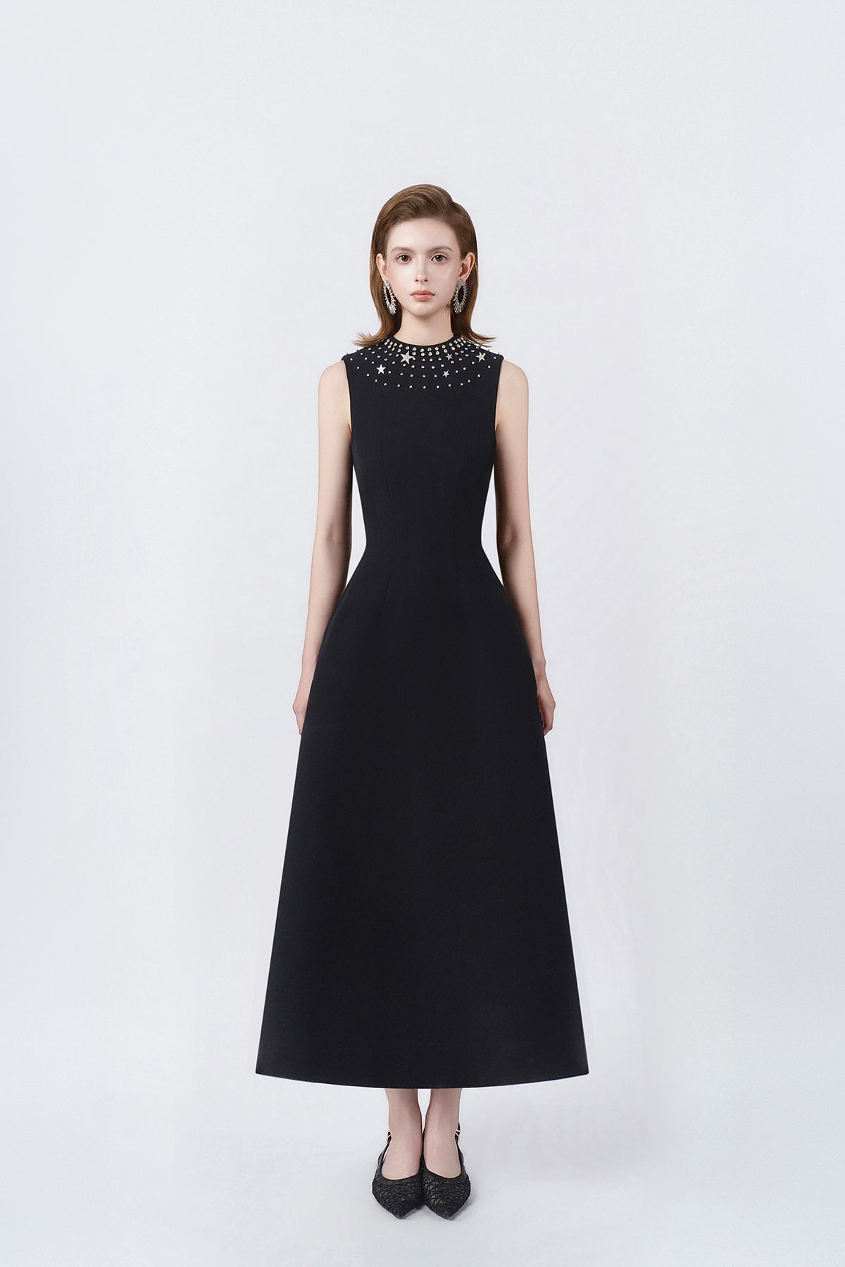 model in a black rhinestone-neckline A-line midi dress, DeTHEIA