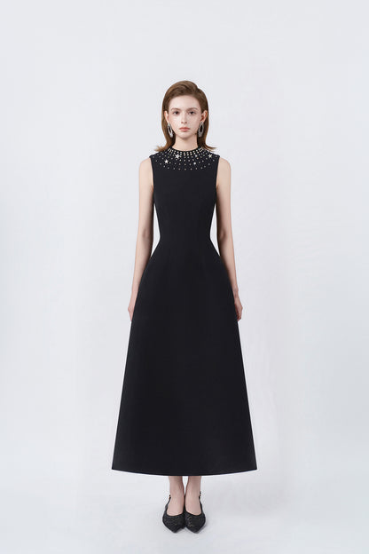 model in a black rhinestone-neckline A-line midi dress, DeTHEIA