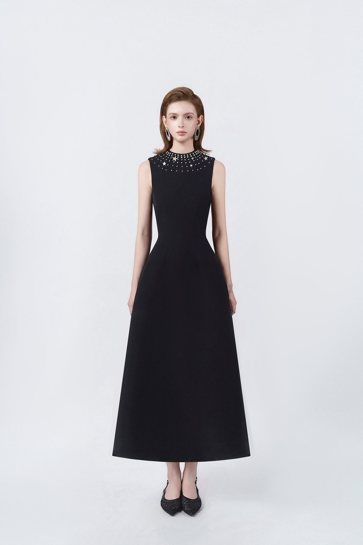 model in a black rhinestone-neckline A-line midi dress, DeTHEIA