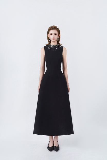 model in a black rhinestone-neckline A-line midi dress, DeTHEIA