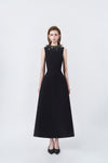 model in a black rhinestone-neckline A-line midi dress, DeTHEIA