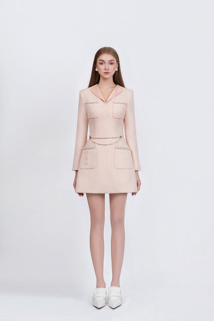 Woman wearing a light pink dress with a white background