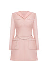 Pink dress with pearl embellishments on a white background