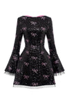 Black dress with pink bow pattern on a white background