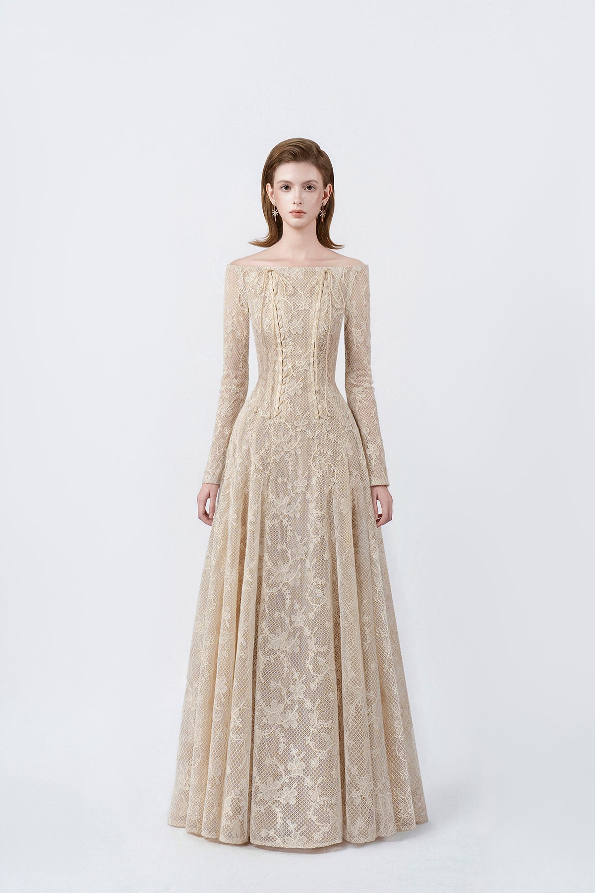 model in a beige off-the-shoulder long-sleeve maxi dress, DeTHEIA